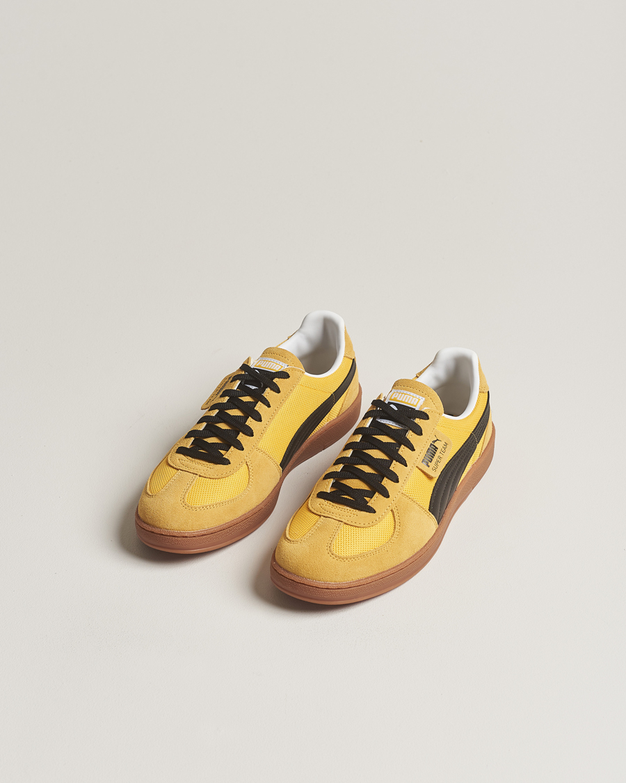 Black and yellow puma sneakers online